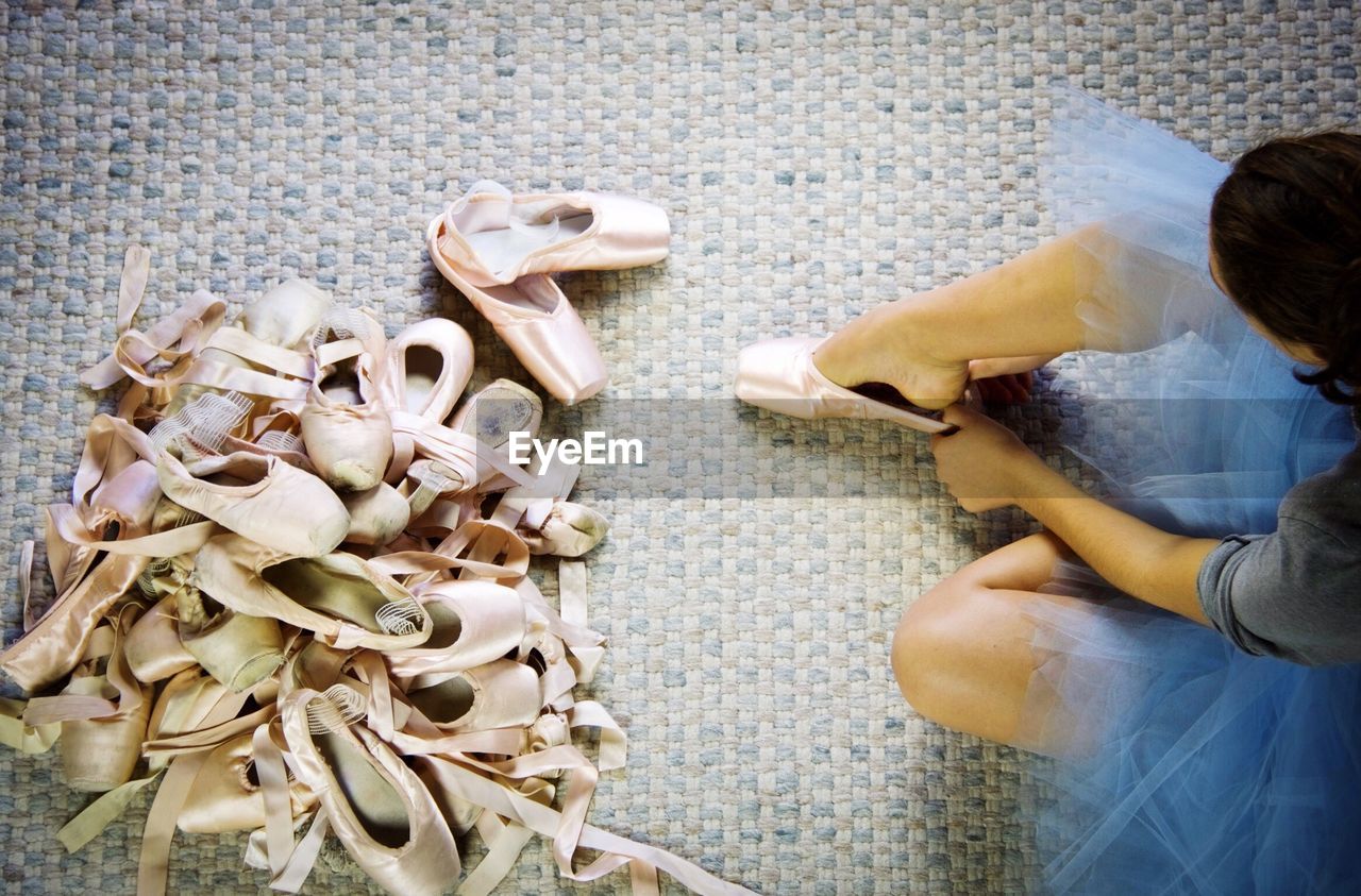 High angle view of woman wearing ballet shoe