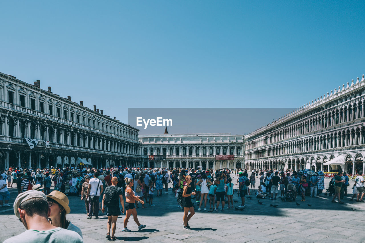 People at st marks square against sky