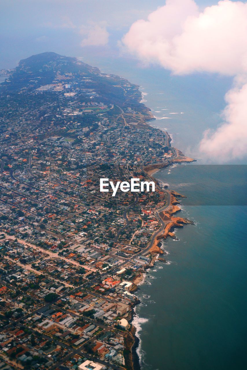Aerial view of sea by buildings in city