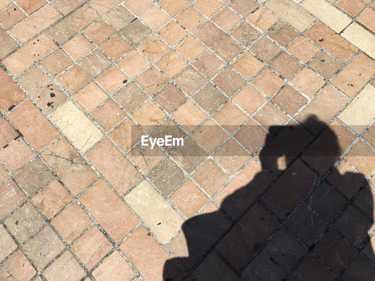 WOMAN WALKING ON COBBLESTONE