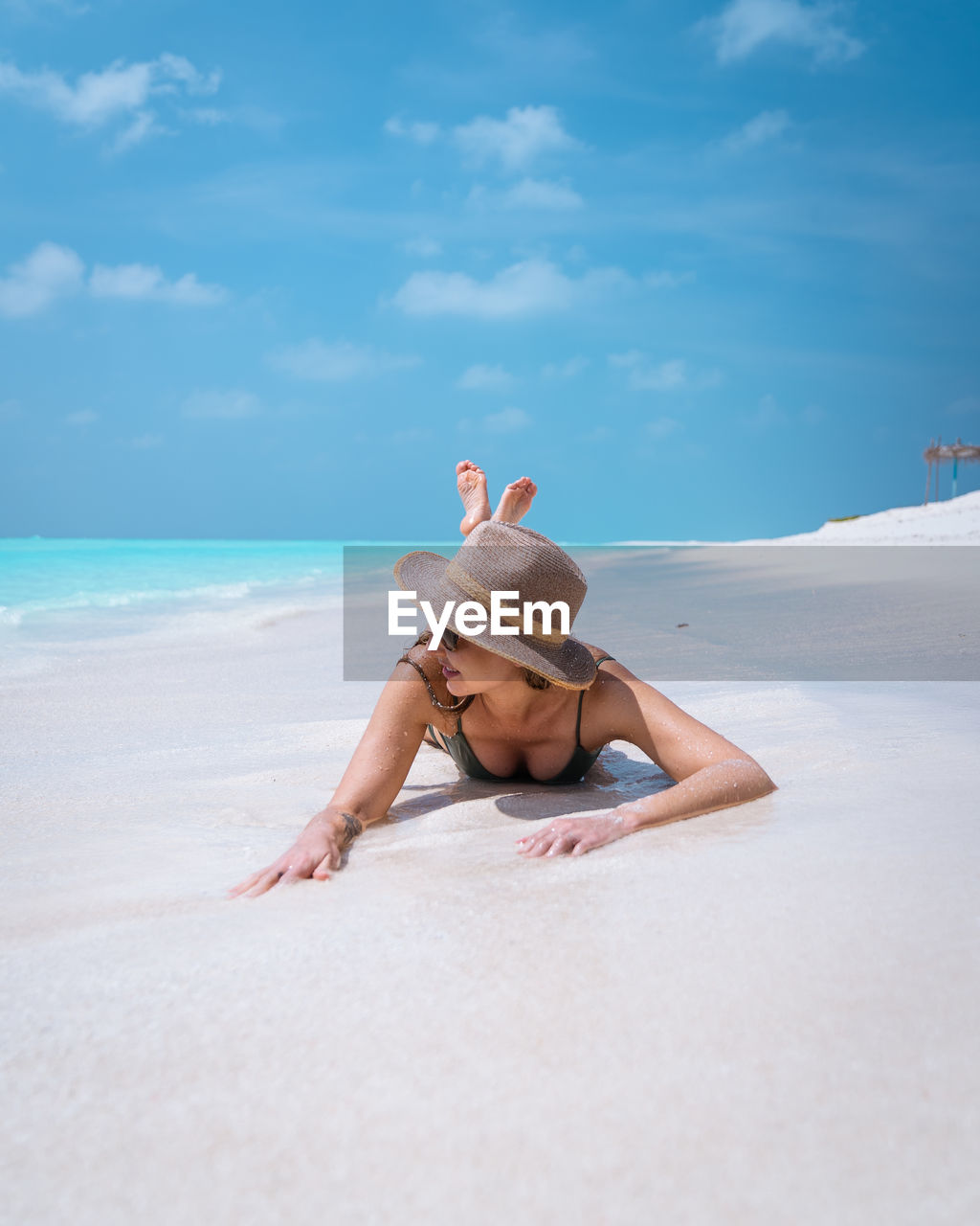 Female on white sand beach in maldives