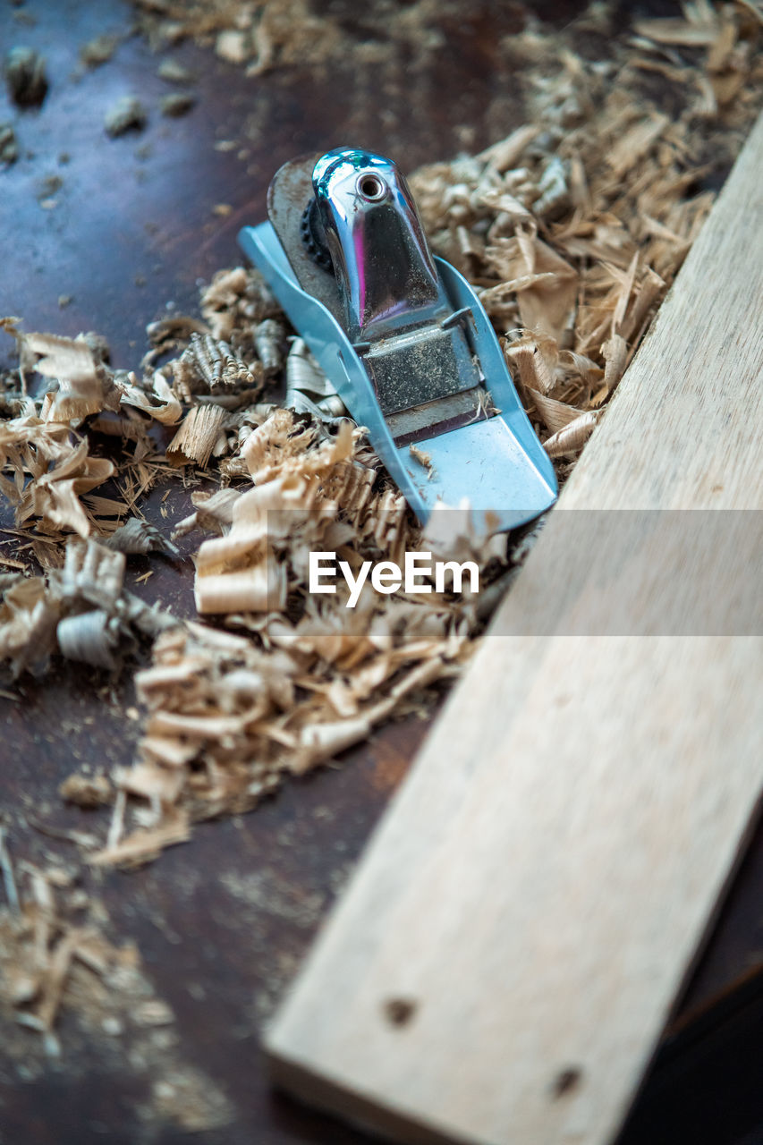 High angle view of wood shavings working.