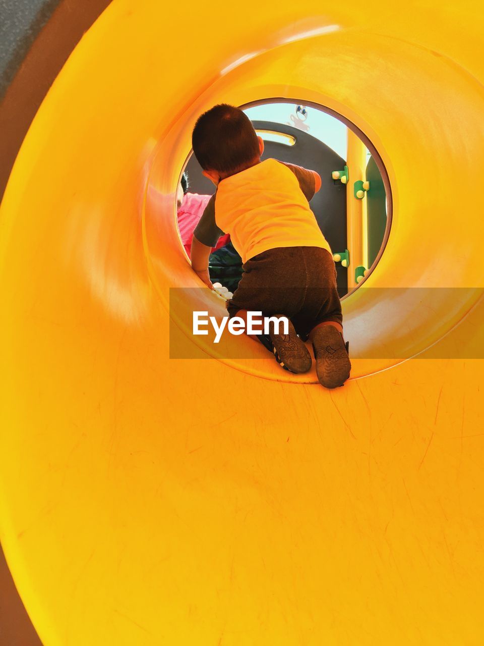 Playful boy in slide