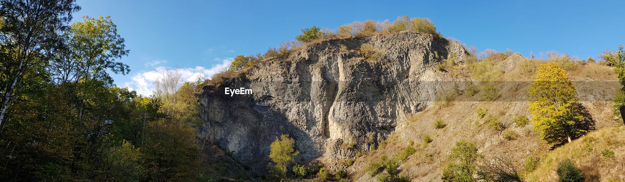 LOW ANGLE VIEW OF ROCK FORMATION ON MOUNTAIN AGAINST SKY