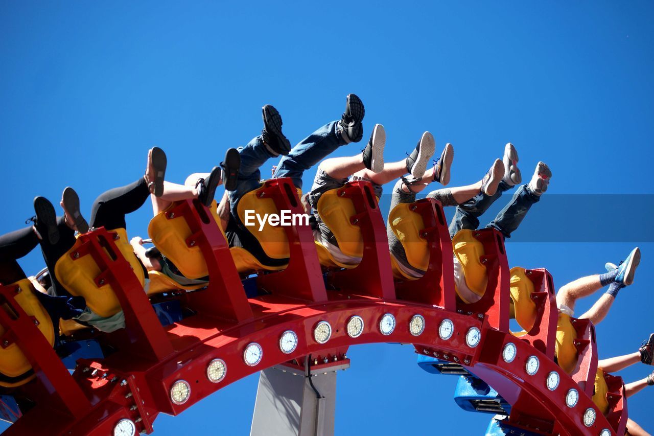 LOW ANGLE VIEW OF CAROUSEL AGAINST CLEAR BLUE SKY