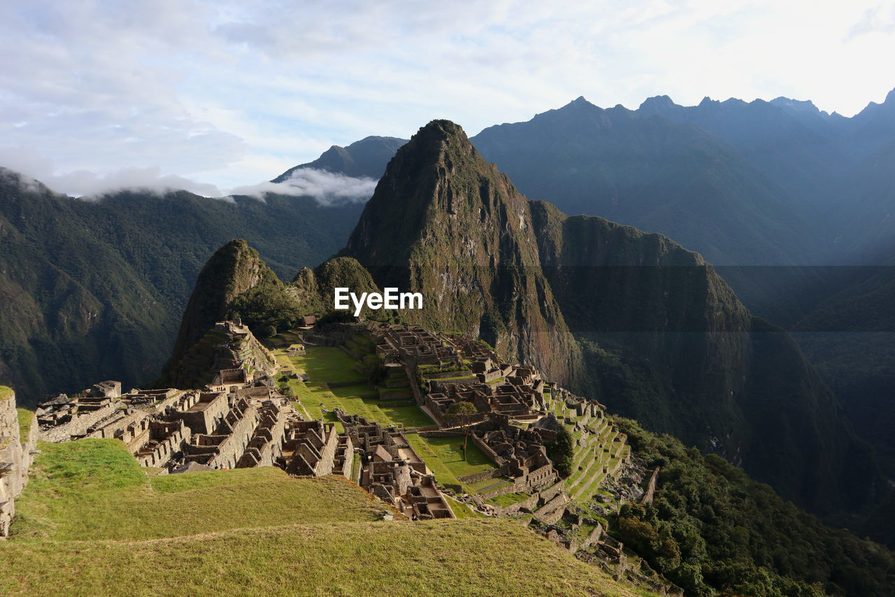 Scenic view of mountains against cloudy sky - machu picchu