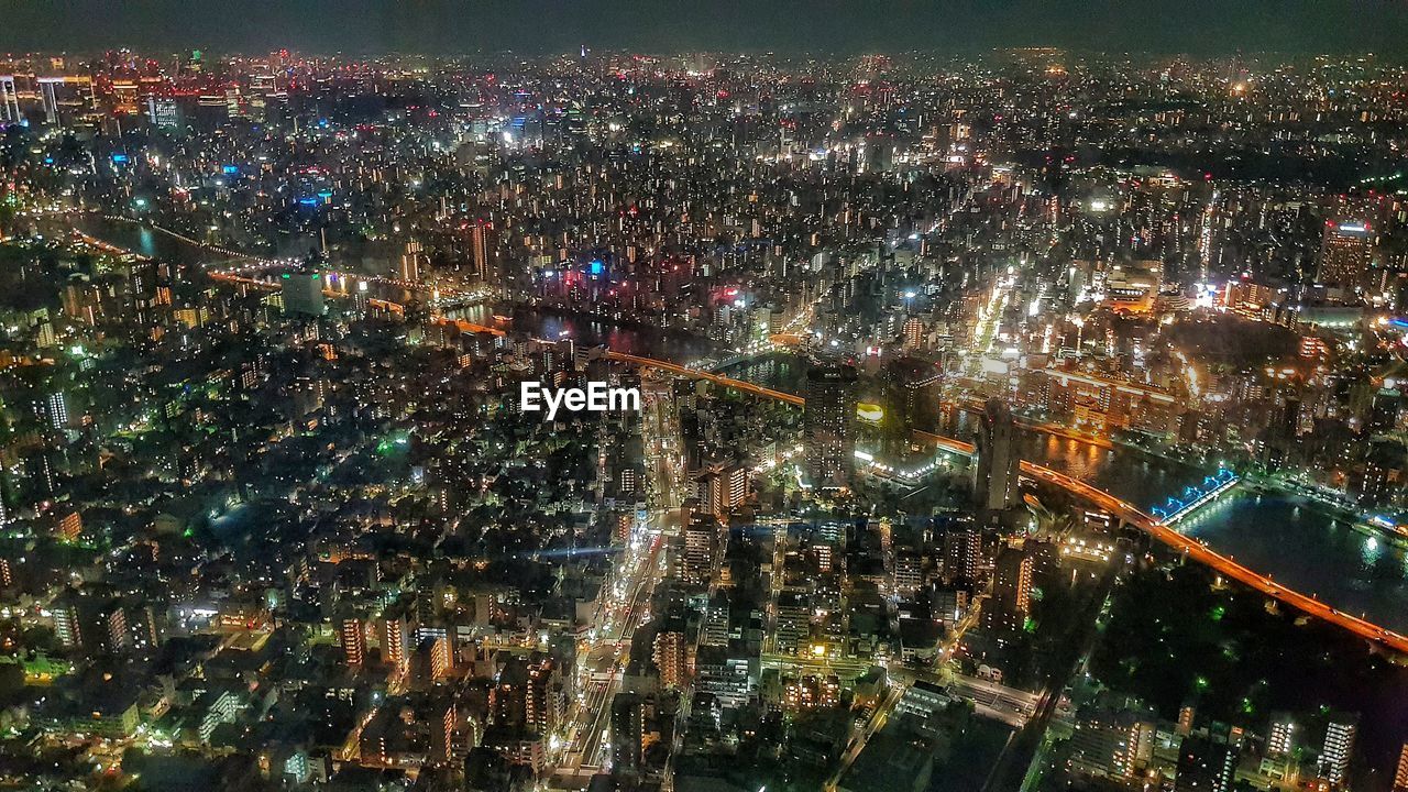 High angle view of illuminated city buildings at night