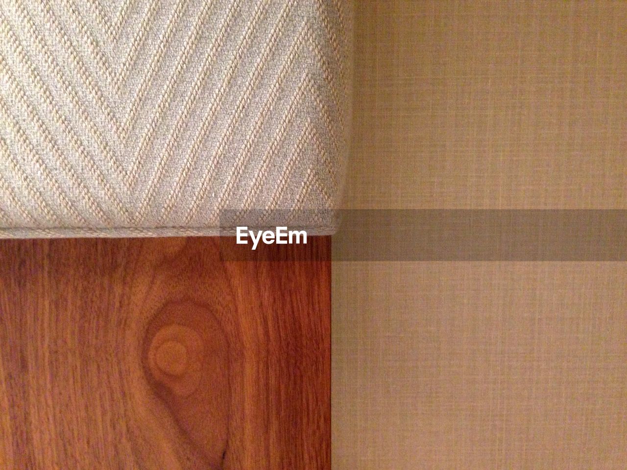 Cropped image of cushion on wooden head rest at home