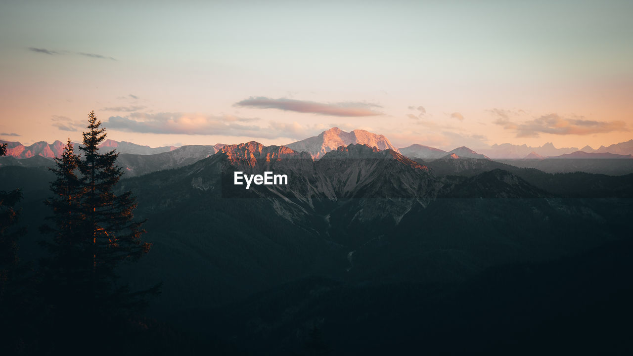 Scenic view of mountains against sky at sunset