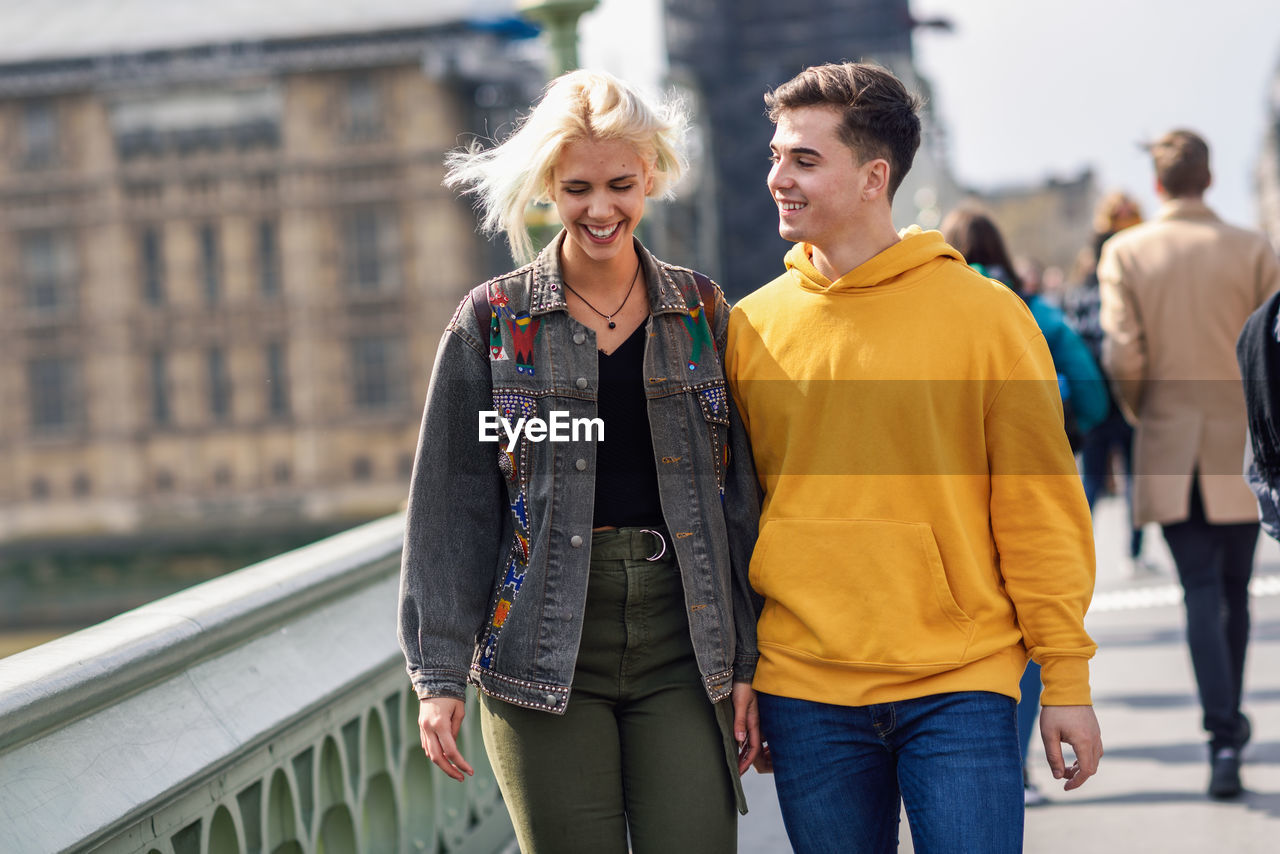 Smiling couple talking in city