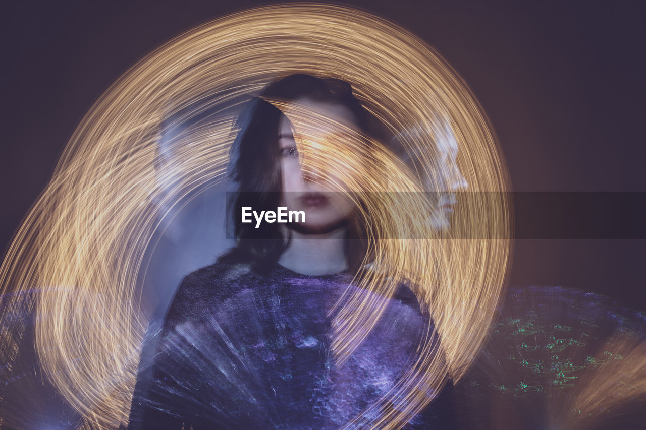 Multiple exposure of woman by firework display