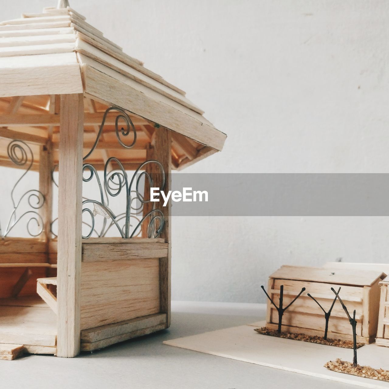 WOODEN TABLE AND CHAIRS ON FLOOR AGAINST HOUSE