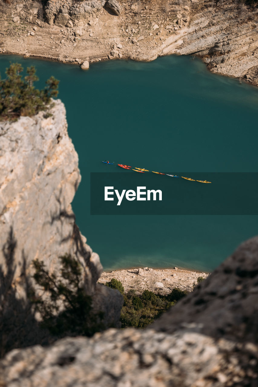 Several kayaks float on the emerald lake in the mountains. congost de mont rebei, catalonia, spain