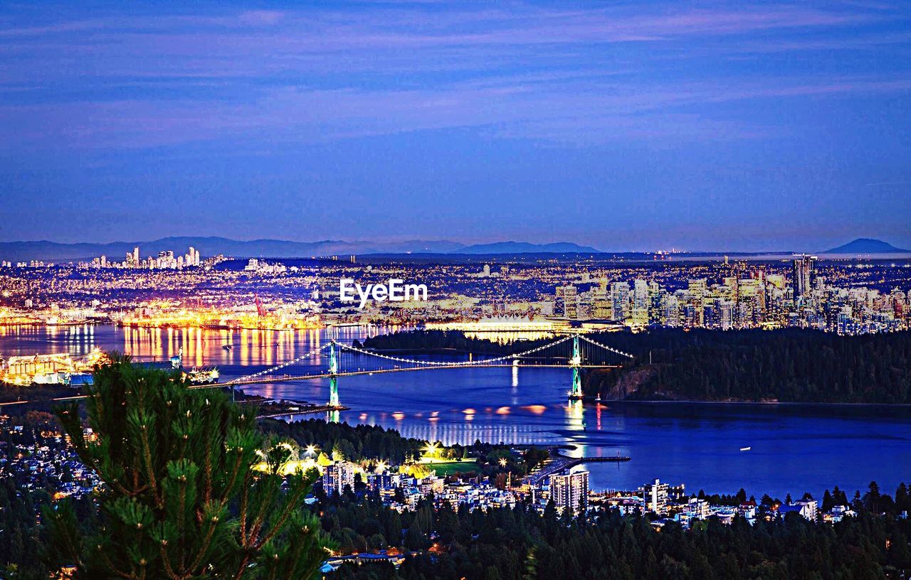 VIEW OF ILLUMINATED CITYSCAPE AGAINST CLEAR SKY