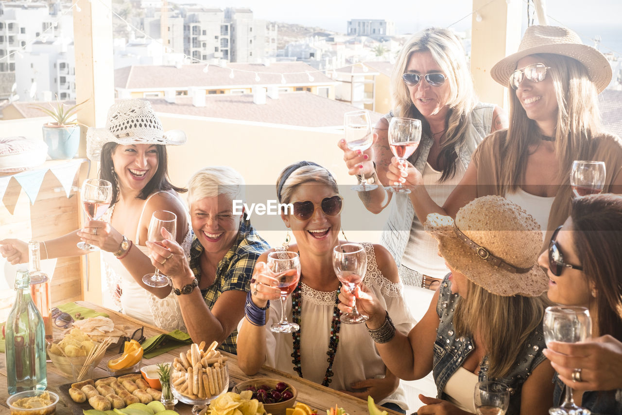 Smiling women enjoying while sitting at restaurant