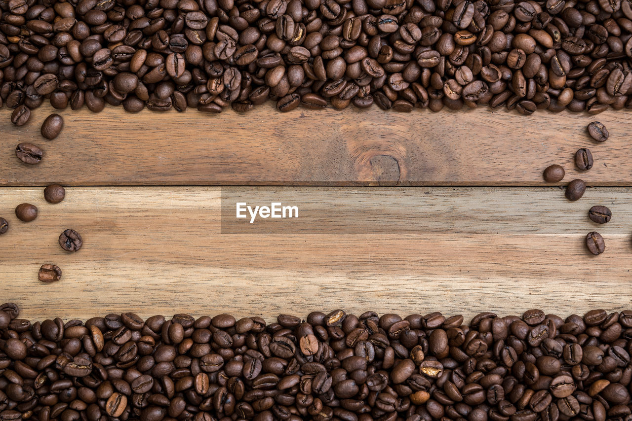 Directly above shot of roasted coffee beans on wooden table