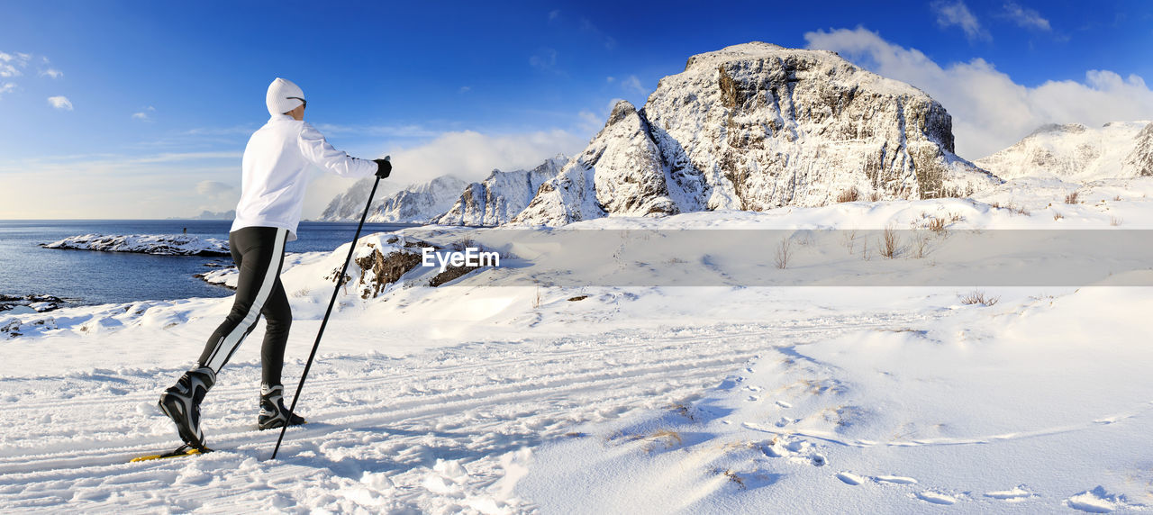 Mature woman skiing on snowcapped mountain