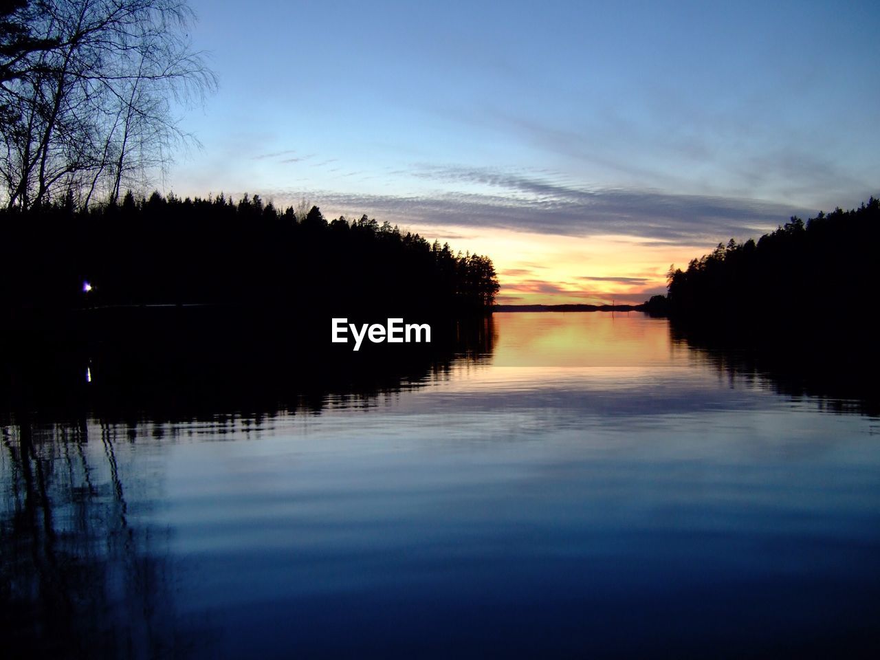 SUNSET OVER CALM LAKE