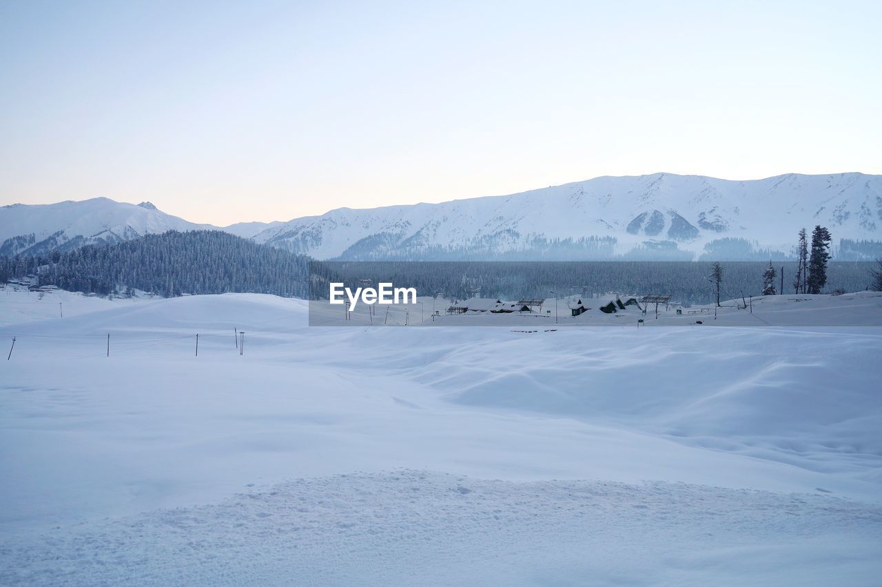Scenic view of snow covered mountains against sky