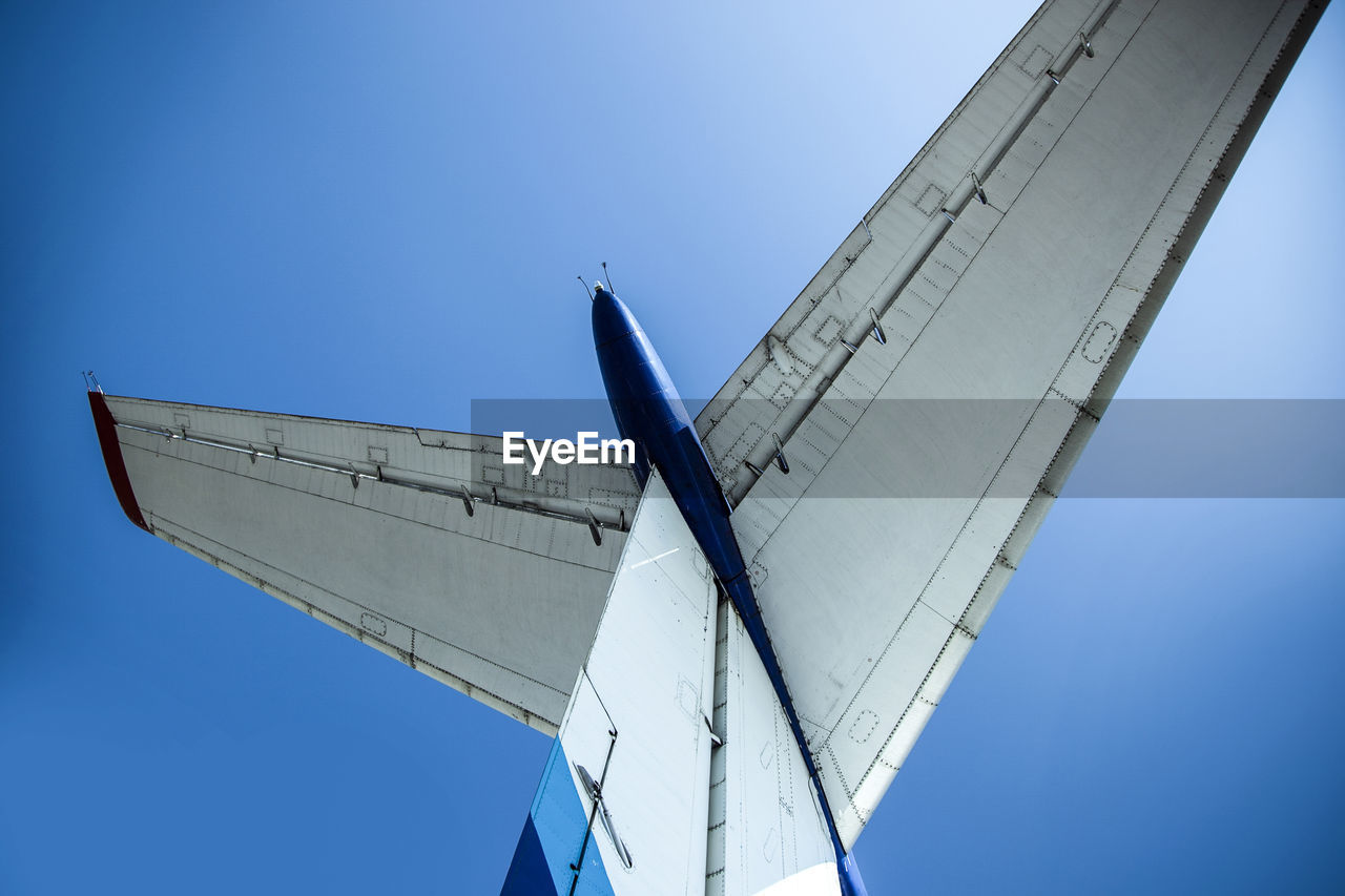 The tail of the plane against the blue sky close-up