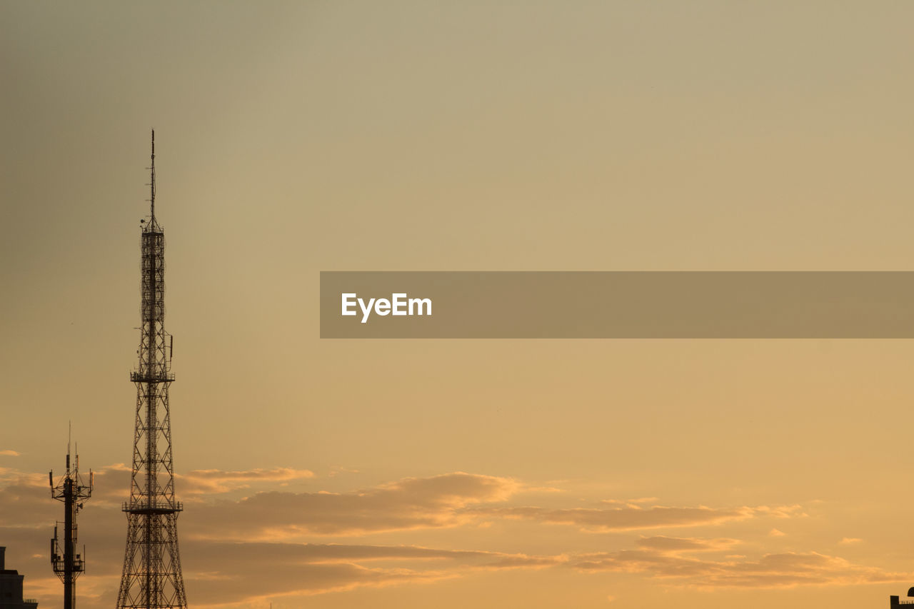 COMMUNICATIONS TOWER AGAINST SKY DURING SUNSET