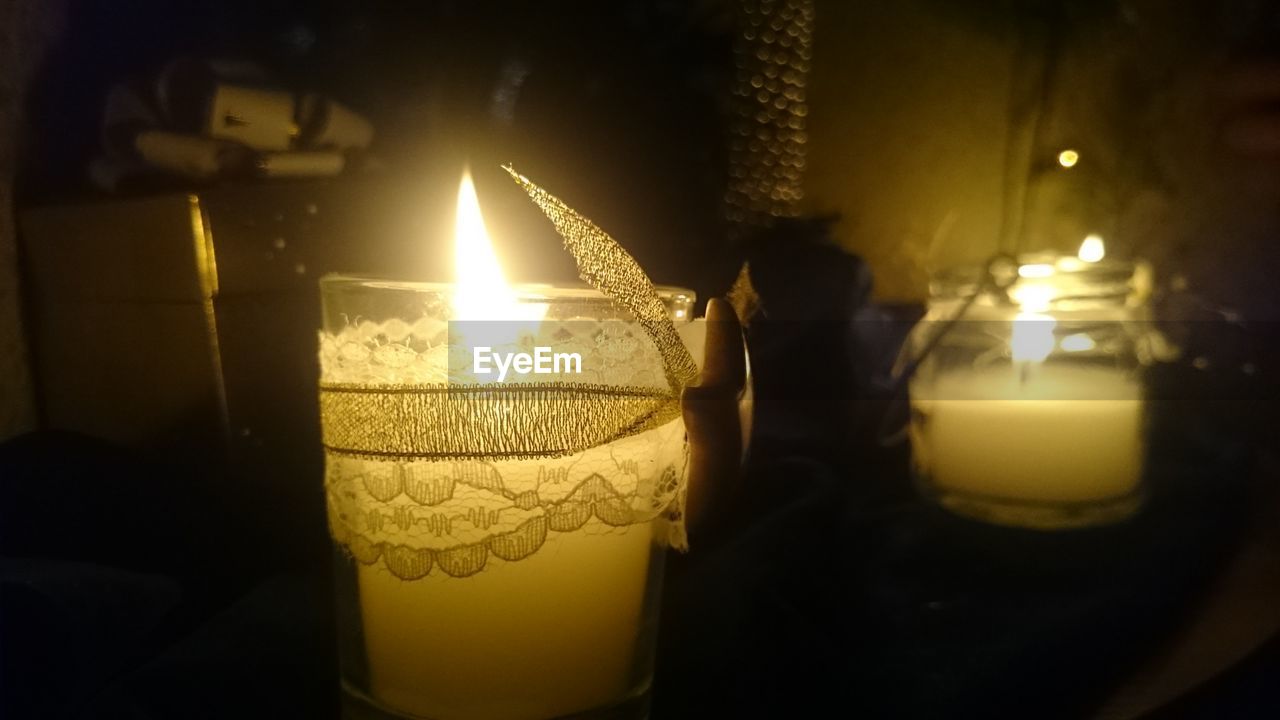 CLOSE-UP OF ILLUMINATED LAMP ON TABLE