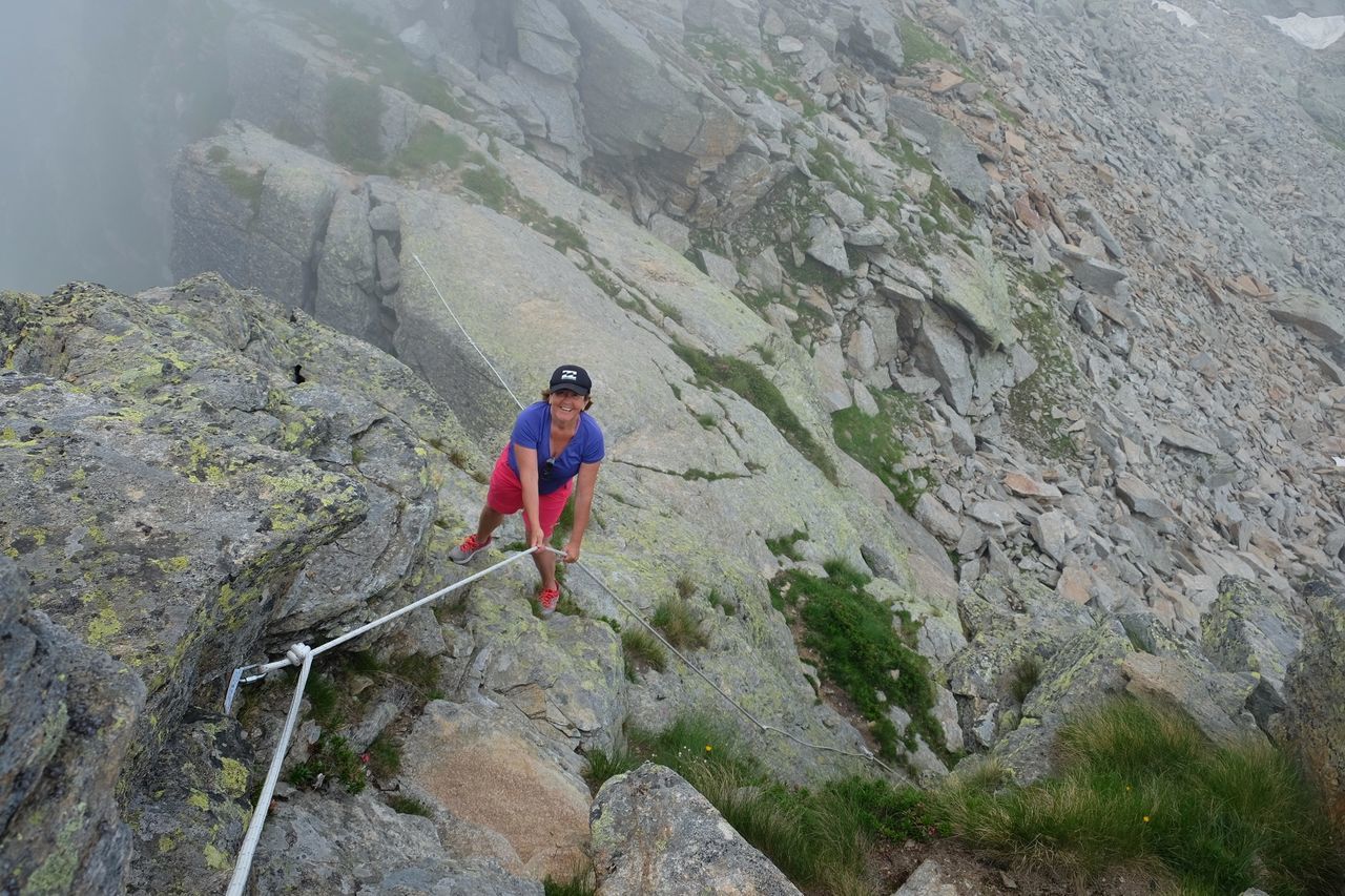 FULL LENGTH OF MAN ON ROCKS BY MOUNTAINS