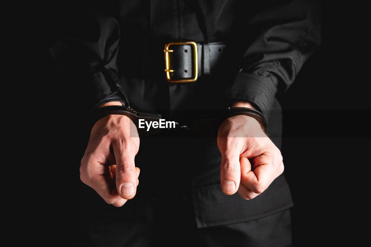 hand, men, adult, one person, clothing, indoors, studio shot, business, black background, arm, black, midsection, finger, person, close-up, businessman