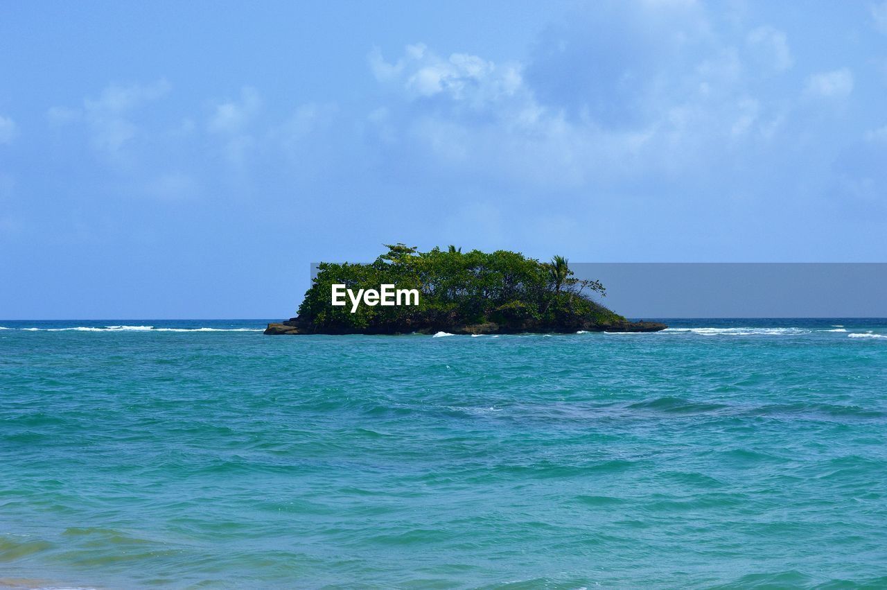 Scenic view of sea against blue sky