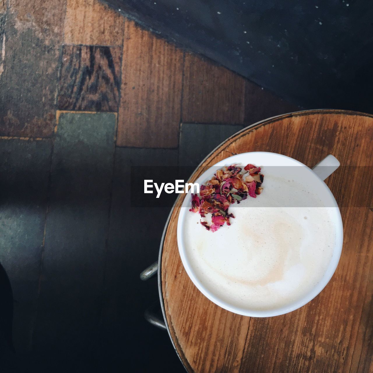 Directly above shot of chai latte served on wooden table