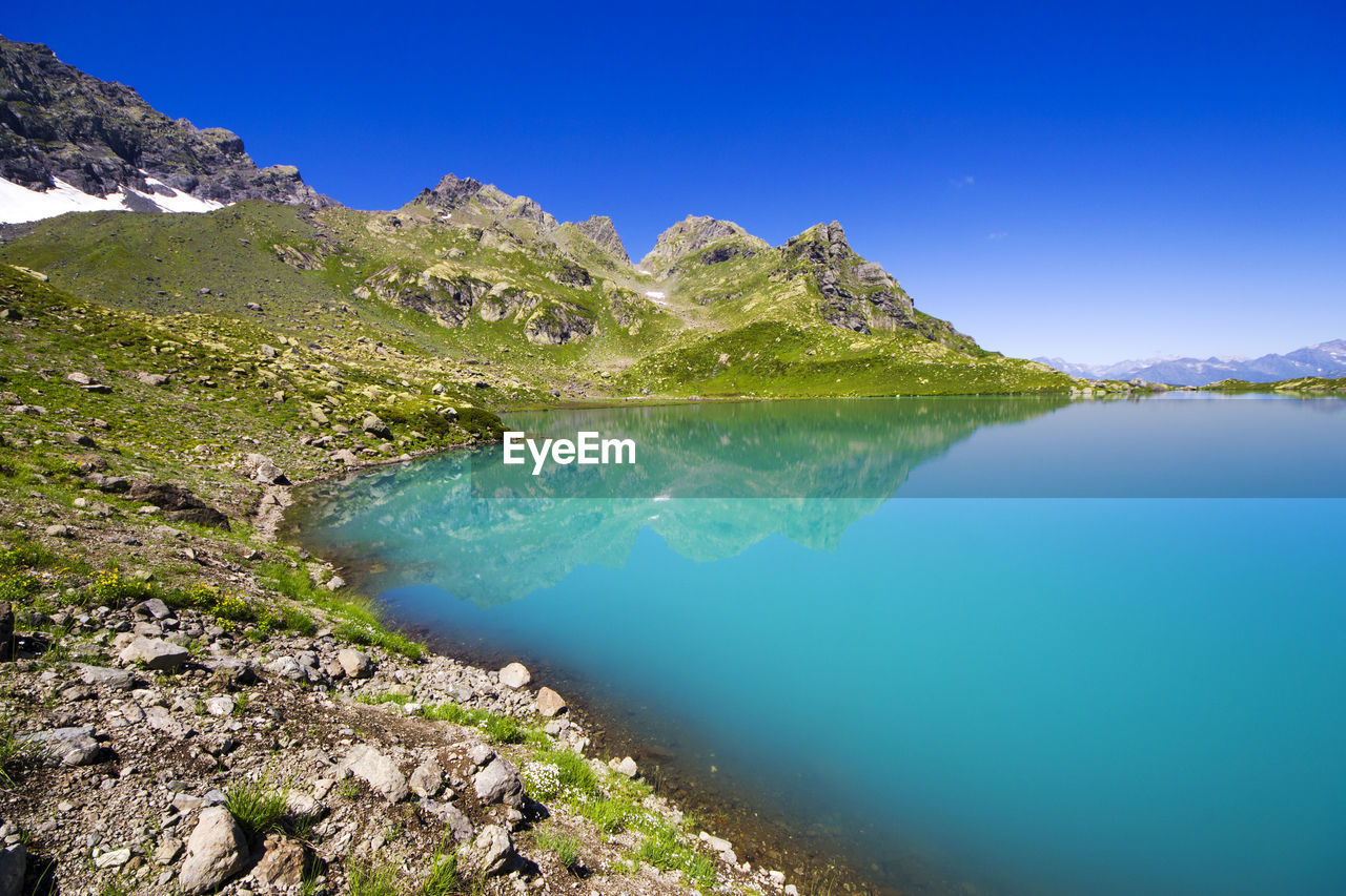 Alpine mountain lake landscape and view, blue beautiful and amazing lake panorama