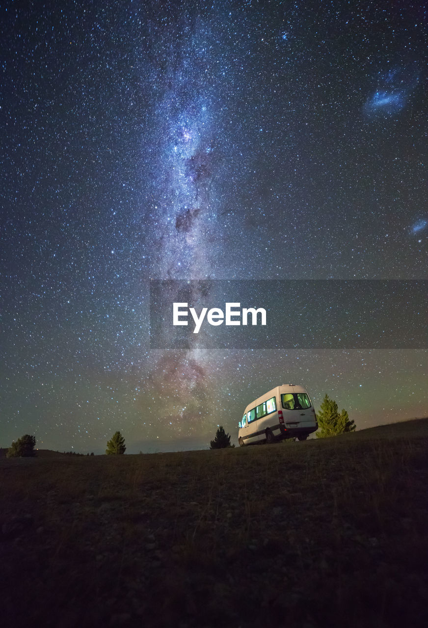 Van against starry sky at night
