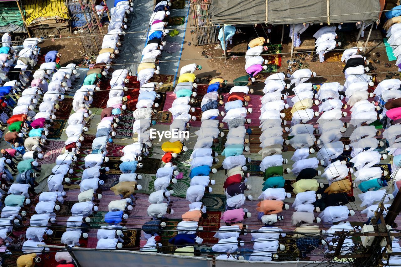 High angle view of people praying on road in city