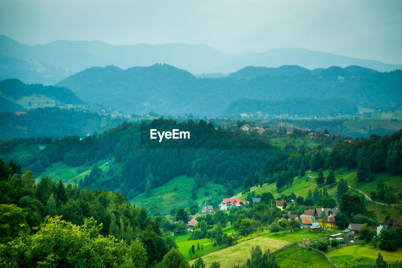 Scenic view of landscape and mountains against sky