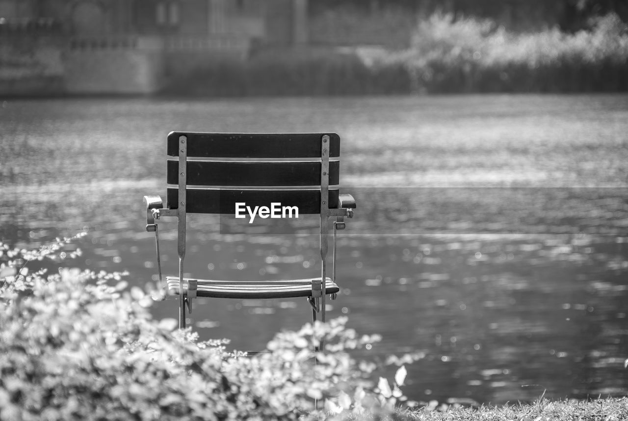 Empty chair against lake