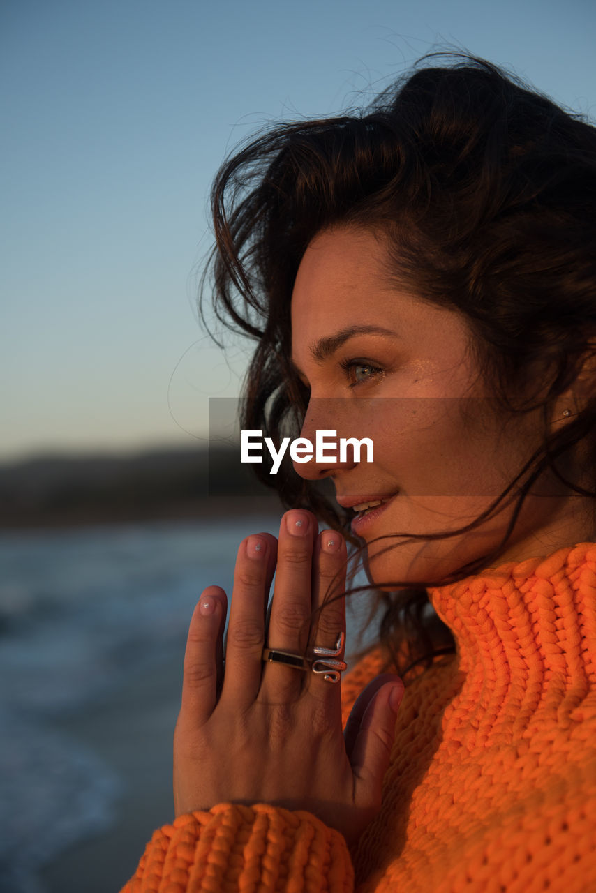 Peaceful woman takes in the view at sunset