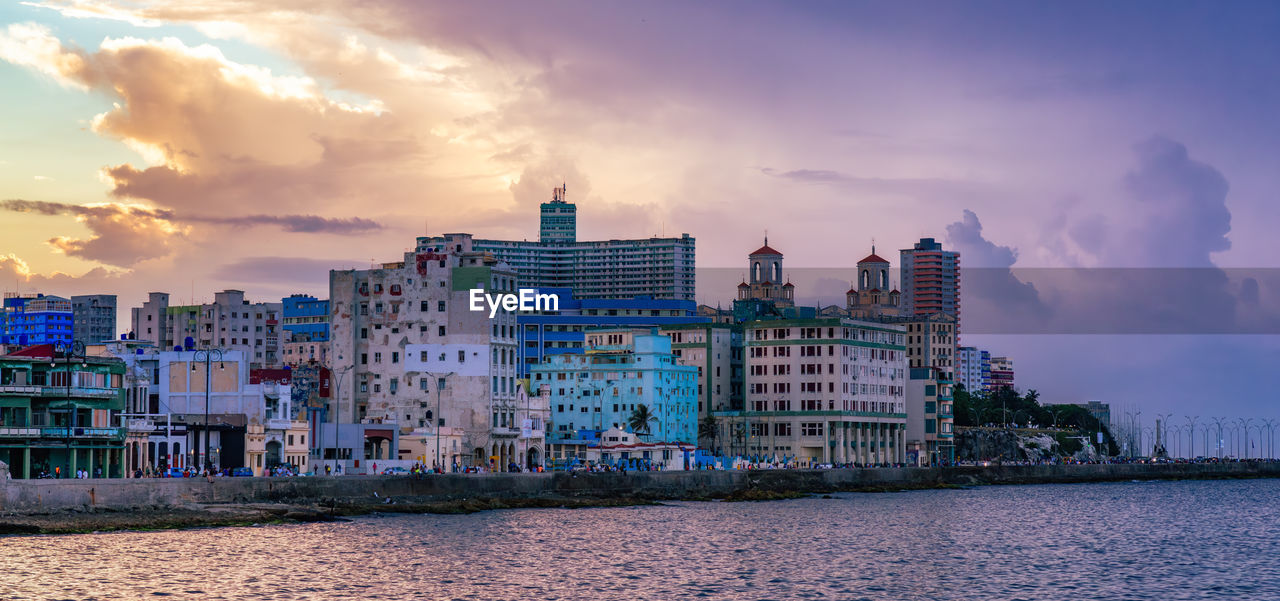 architecture, city, cityscape, sky, building exterior, skyline, horizon, built structure, building, water, dusk, evening, landscape, sunset, sea, cloud, nature, travel destinations, urban skyline, reflection, urban area, travel, residential district, environment, coast, office building exterior, multi colored, land, skyscraper, tourism, landmark, business finance and industry, beach, outdoors, no people, harbor, night, city life, panoramic, house, dramatic sky, street, twilight, beauty in nature, holiday, vacation, construction industry, trip, ocean, industry, downtown district, bay, nautical vessel, scenics - nature