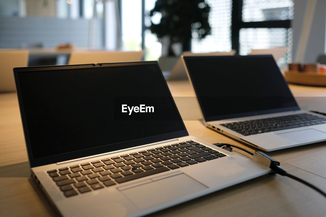 laptop, technology, computer, wireless technology, table, communication, furniture, indoors, business, desk, computer equipment, office, internet, no people, computer network, computer monitor, using laptop, portability, personal computer, keyboard, personal computer hardware, window, computer keyboard, business finance and industry, electronic device