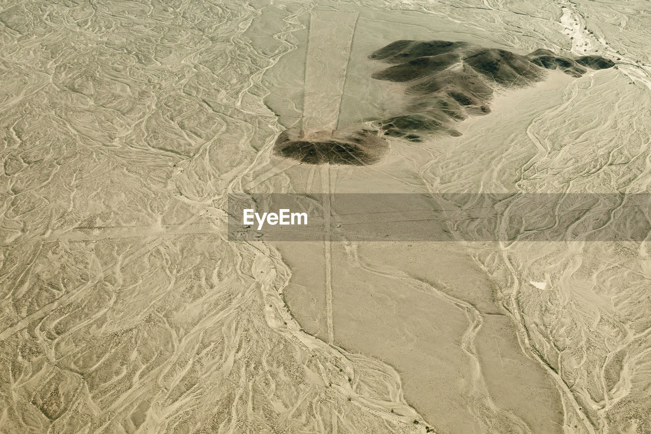 FULL FRAME SHOT OF TIRE TRACKS ON SAND