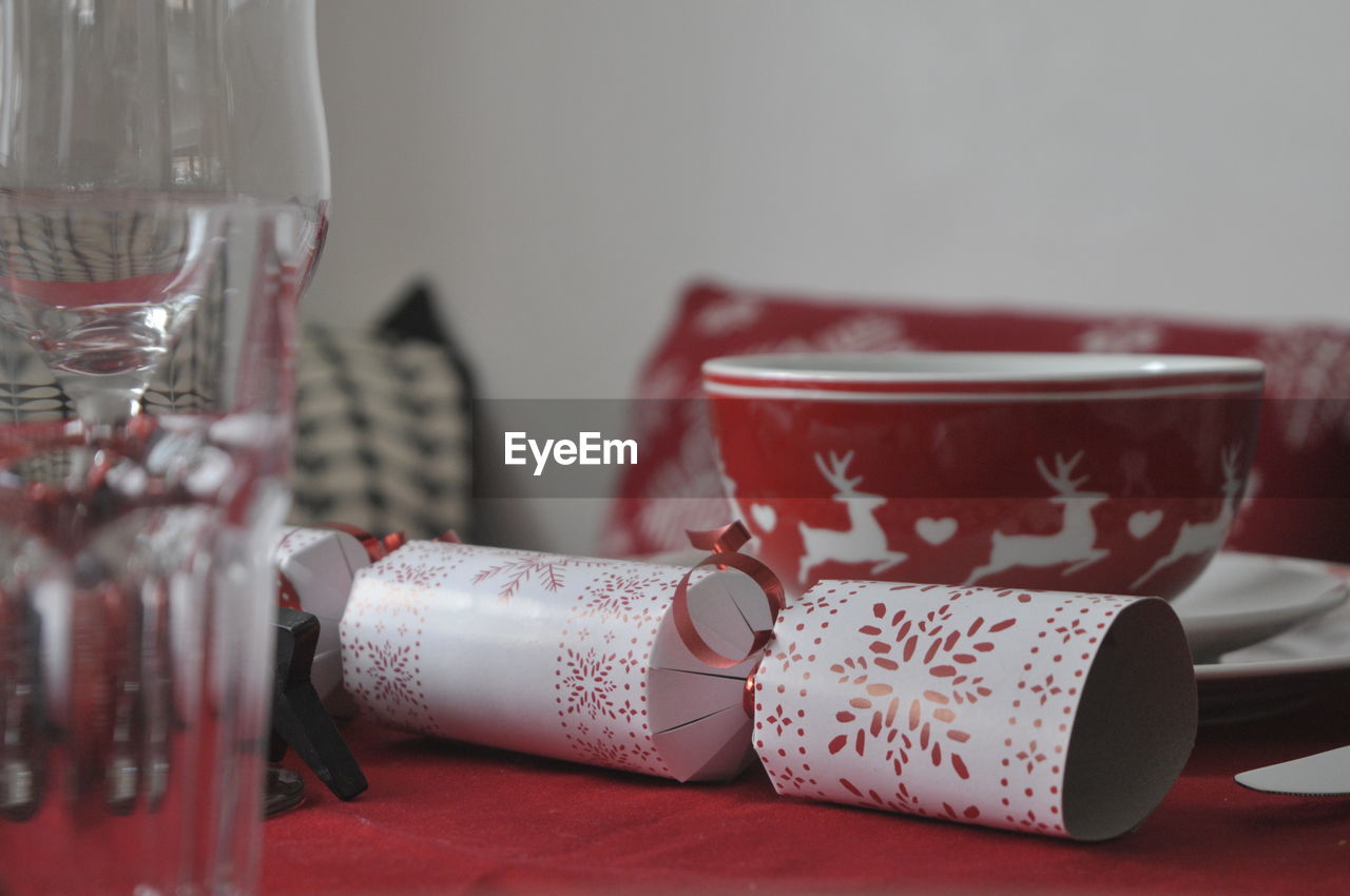 Festive place setting christmas cracker and bowl all red and white. 