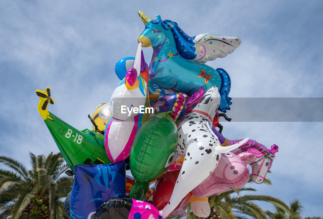 LOW ANGLE VIEW OF BALLOONS AGAINST SKY