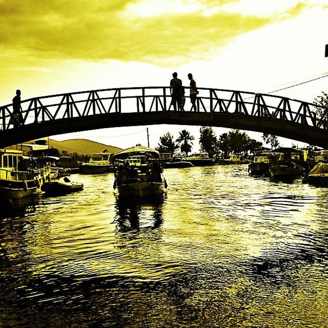 bridge, water, reflection, transportation, architecture, sky, built structure, nature, river, silhouette, morning, cloud, outdoors, men, mode of transportation, waterfront, travel, travel destinations, city, sunlight, waterway, group of people, dusk, day, engineering, nautical vessel