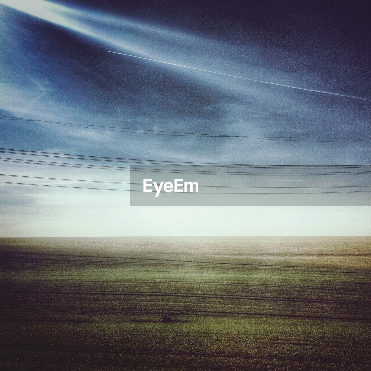 Scenic view of field against sky in foggy weather