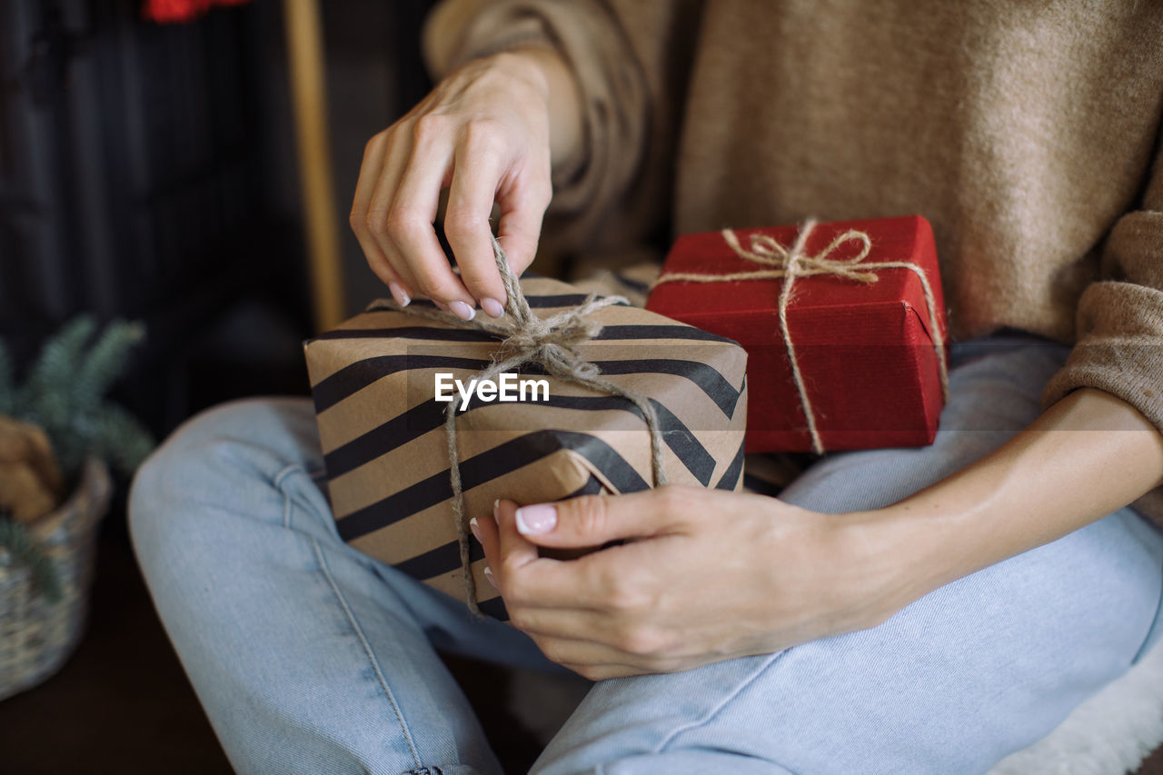 Midsection of woman holding gifts box