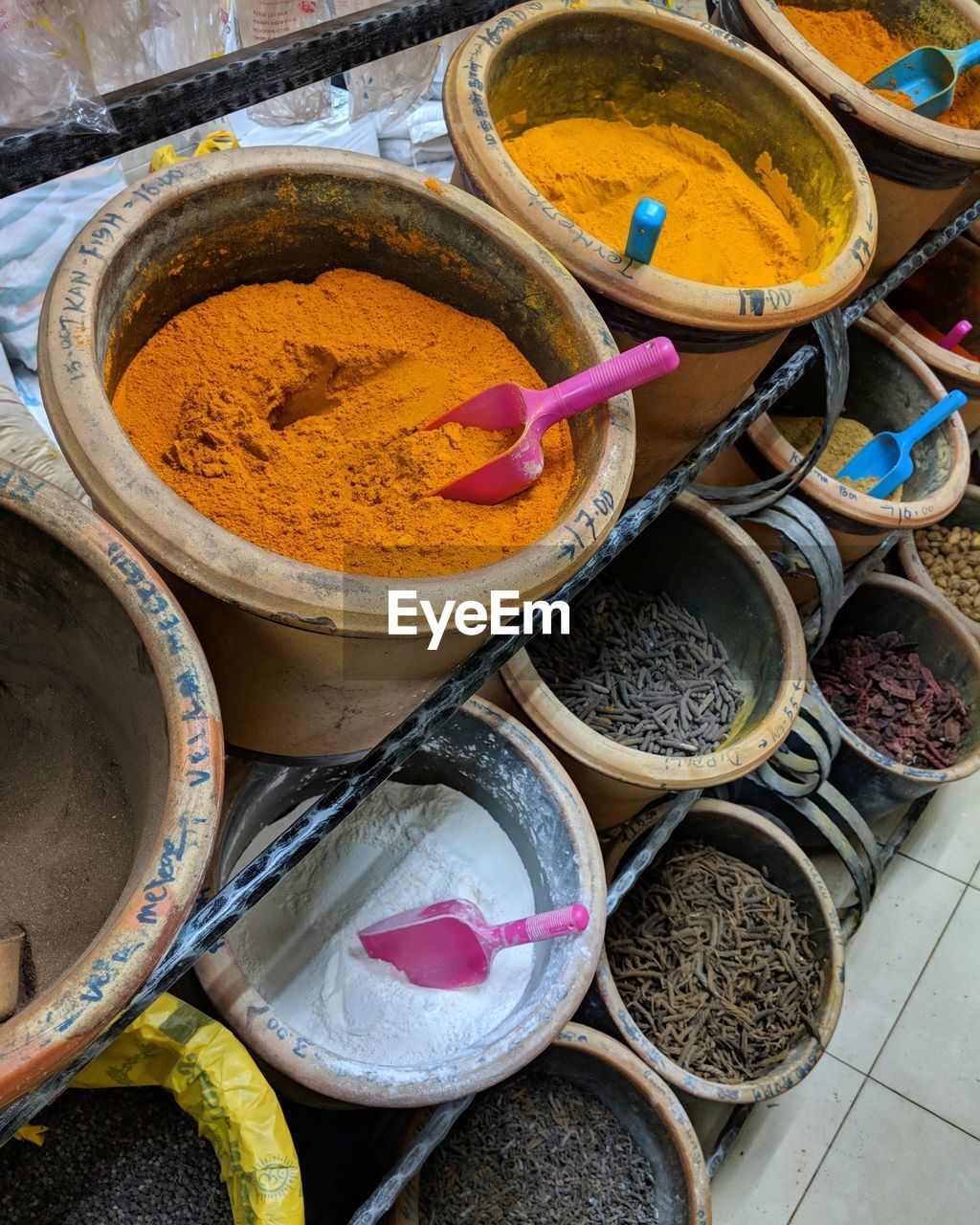 High angle view of various curry powder and spices displayed for sale