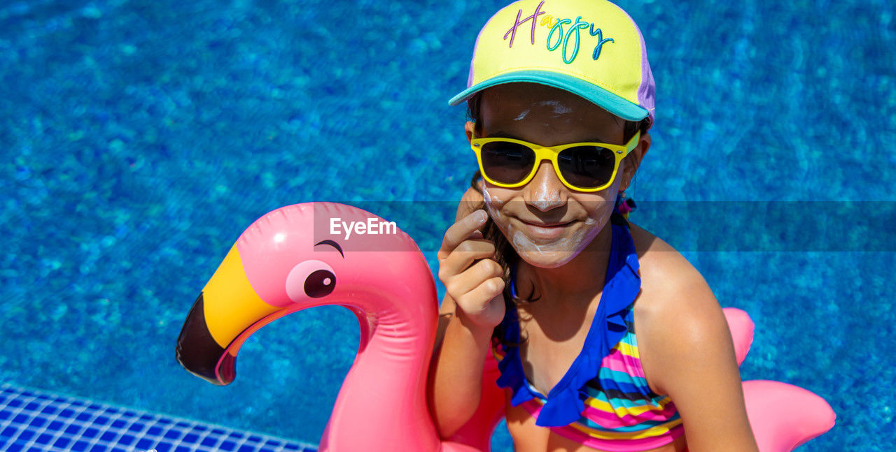 portrait of woman wearing sunglasses while standing against sky