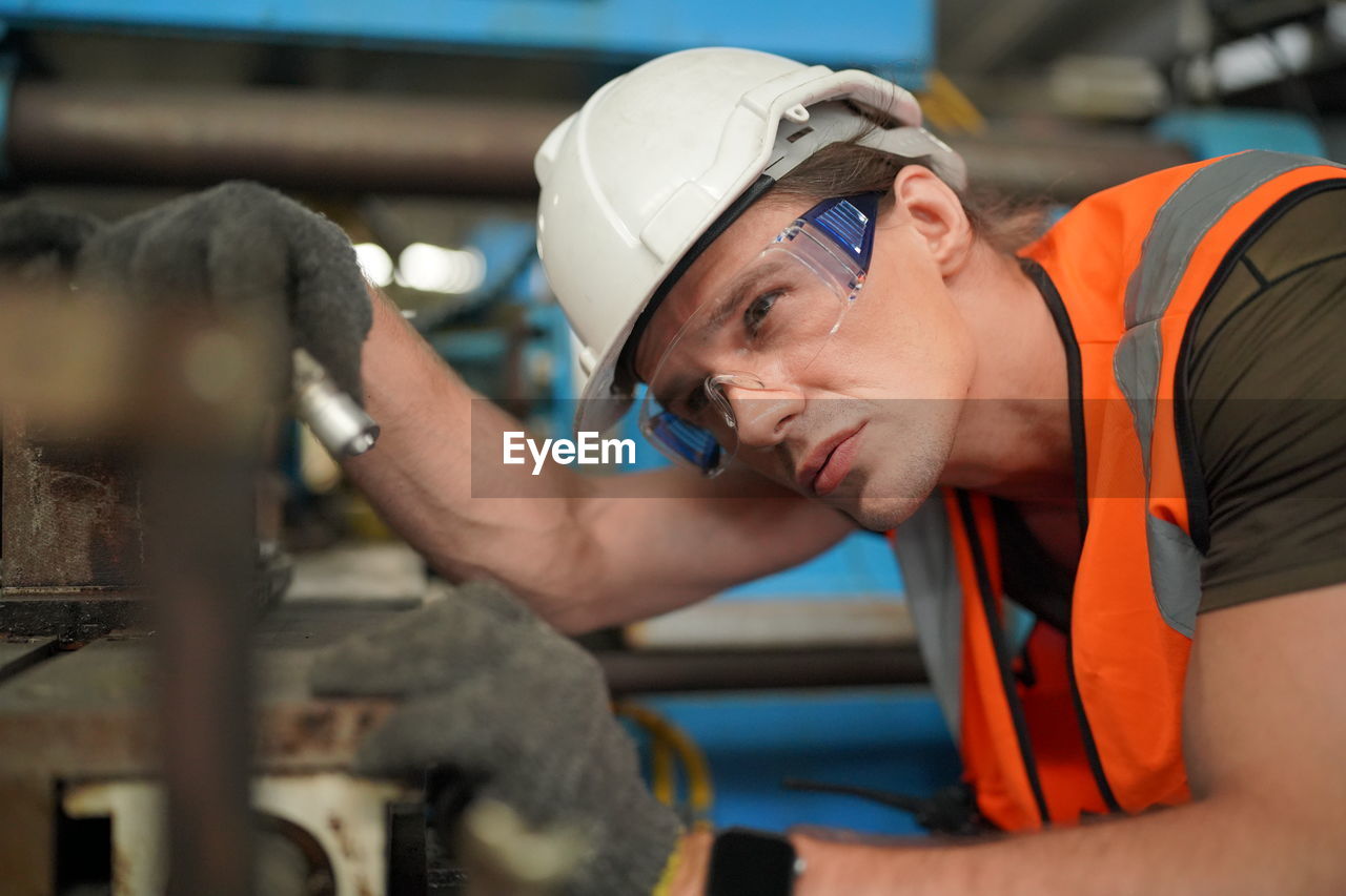 Portrait of male worker standing in the heavy industry manufacturing factory.