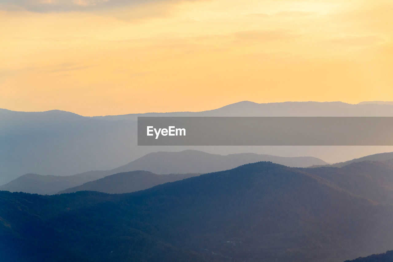 Scenic view of mountains against sky during sunset