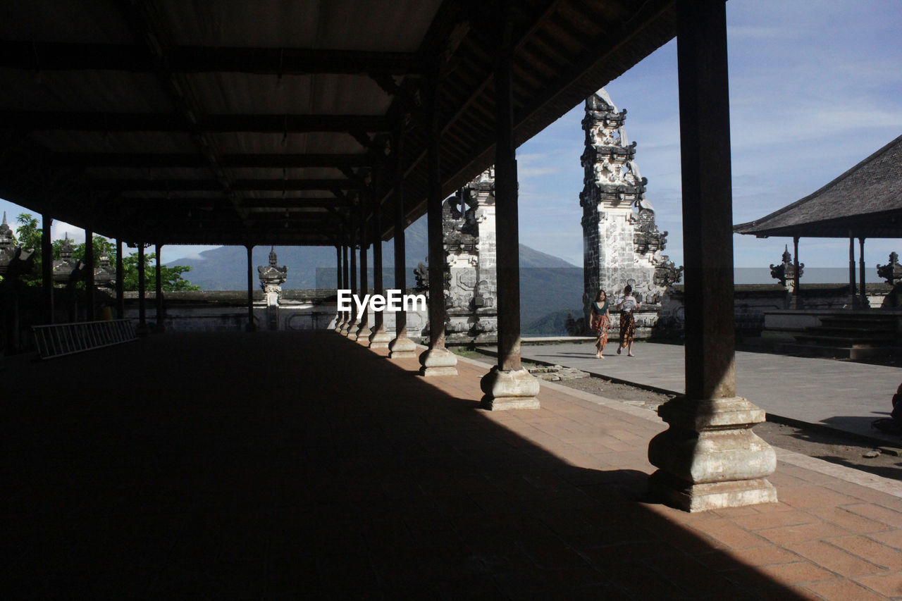 Scenic view of mountain range by buildings against sky