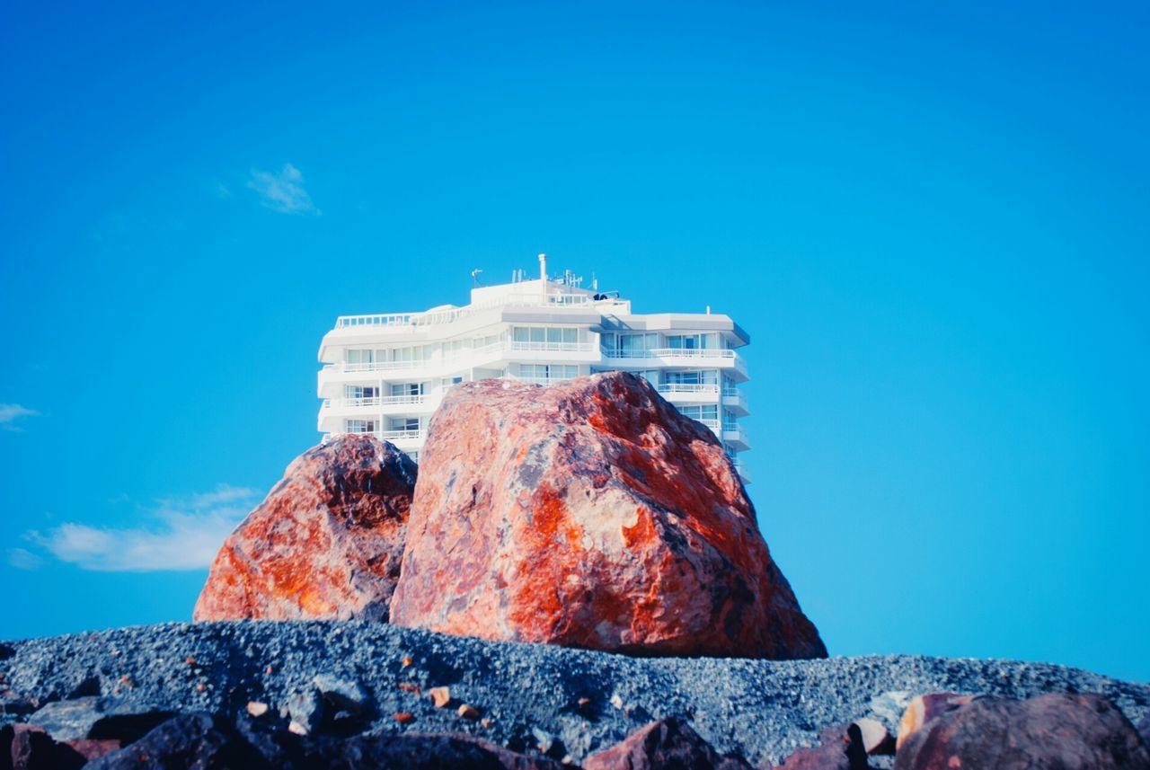 VIEW OF ROCKS AGAINST BLUE SKY